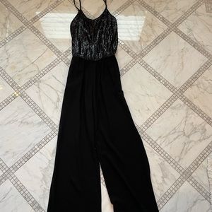 Black jumpsuit with sequins on the top. Size Medium.